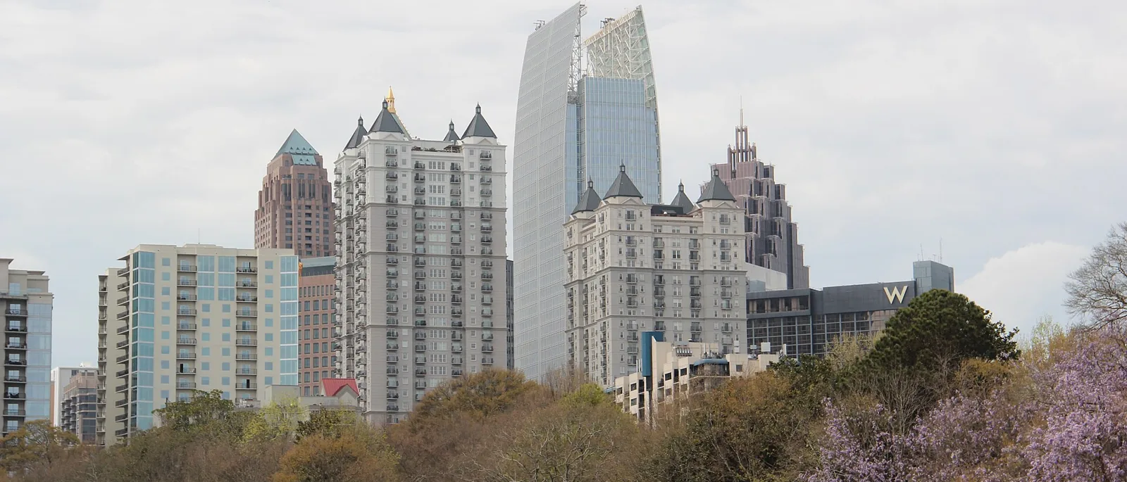 Midtown Atlanta skyline rising over the green meadow of Piedmont Park