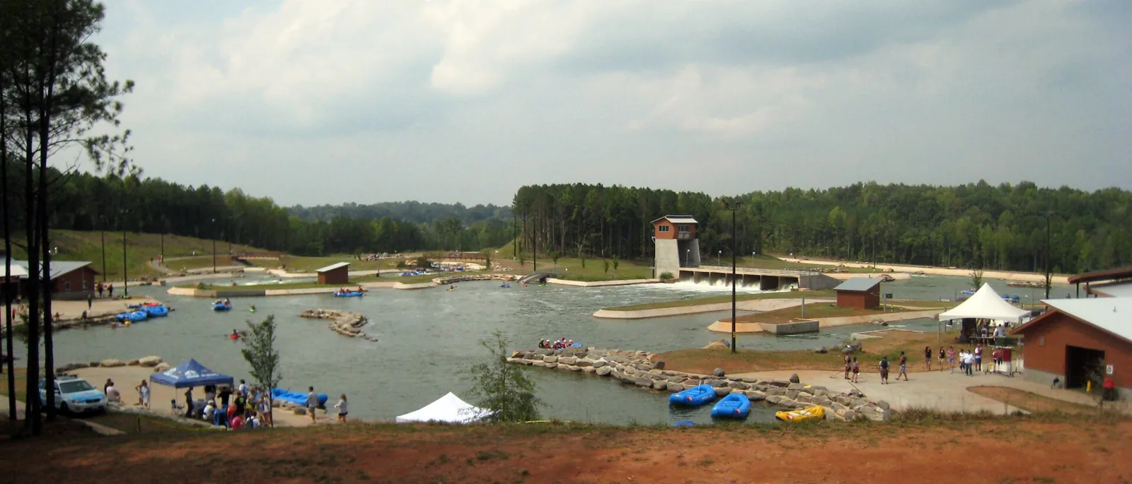 The U.S. National Whitewater Center's channels and rafts seen from the surrounding woodland