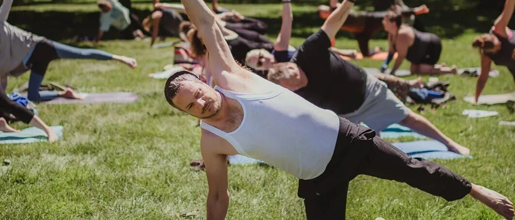 Side-plank rows across the lawn at Mandala Yoga Festival
