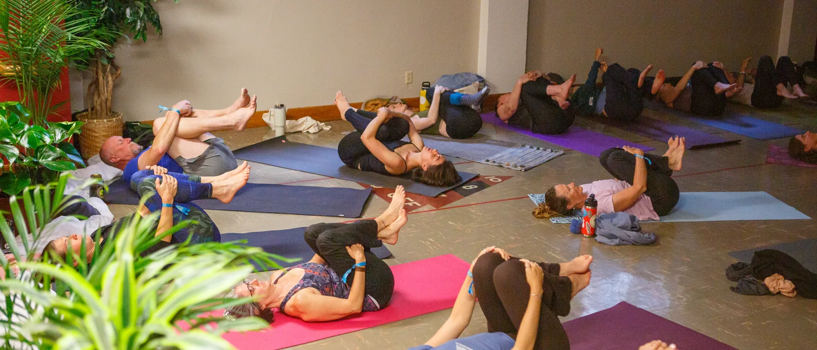 Restorative twist class filling the community hall at Montana YogaFest