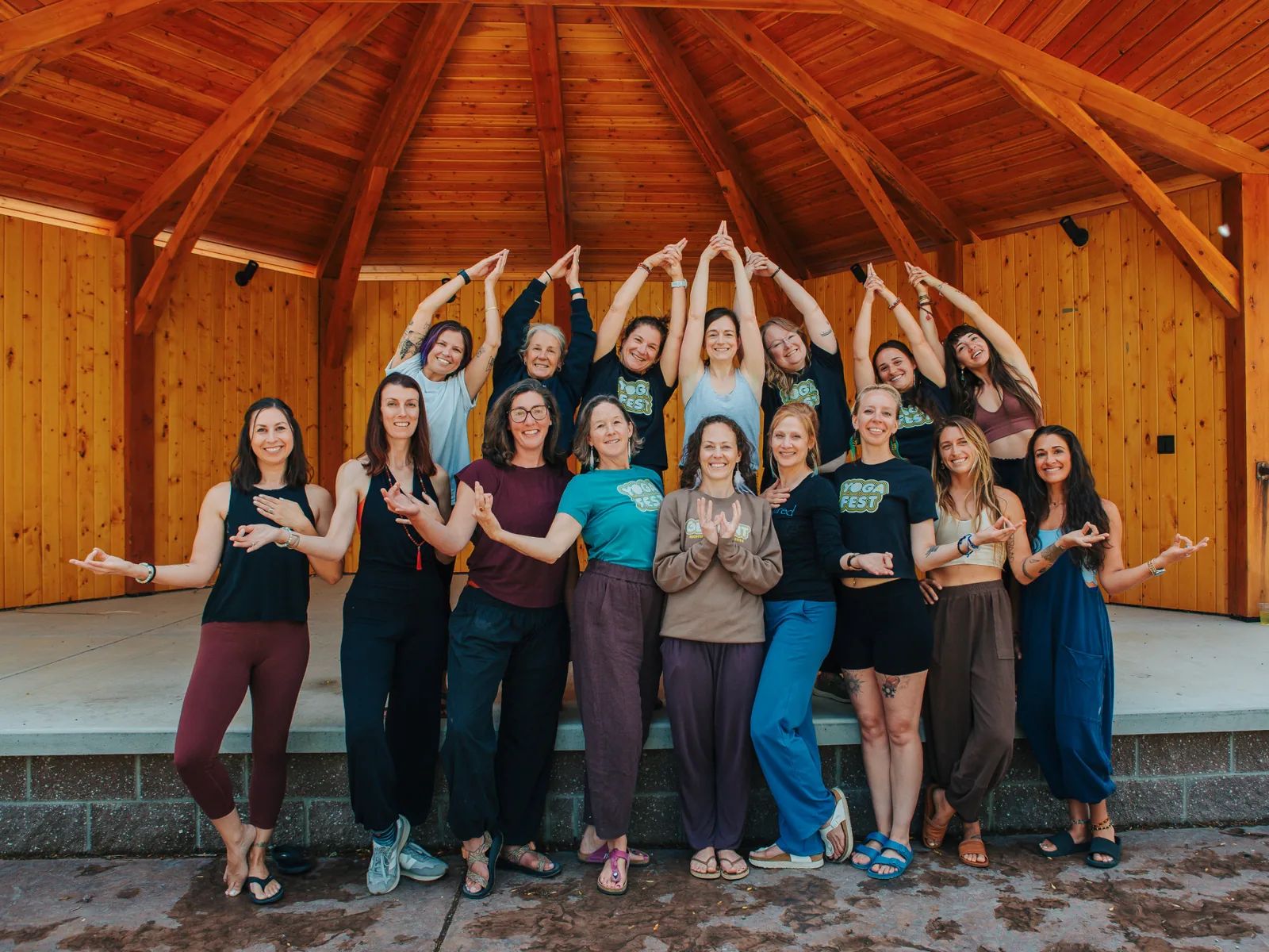 Montana YogaFest teachers gather in mudra under the timber pavilion in Choteau
