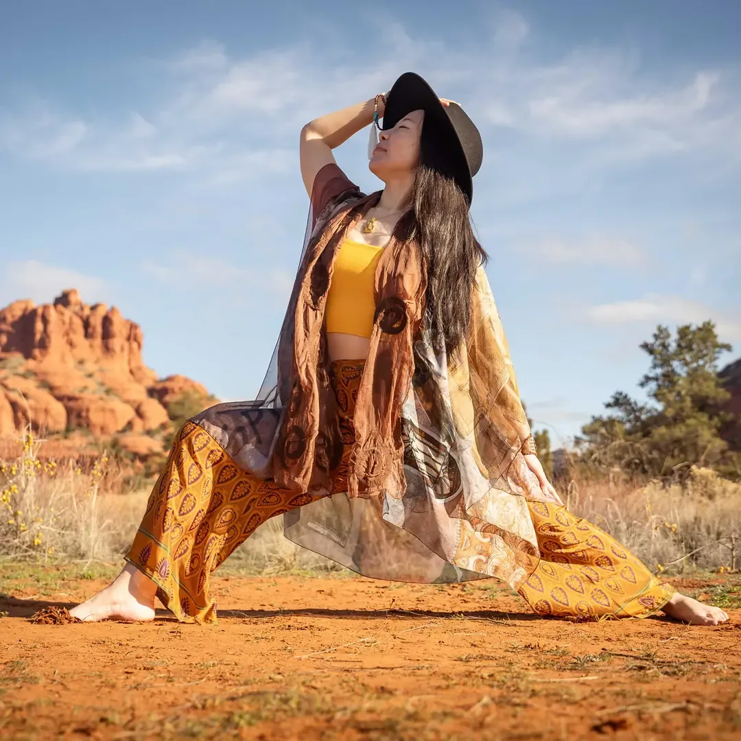 Yoga practitioner in a lunge pose among Sedona's red rocks