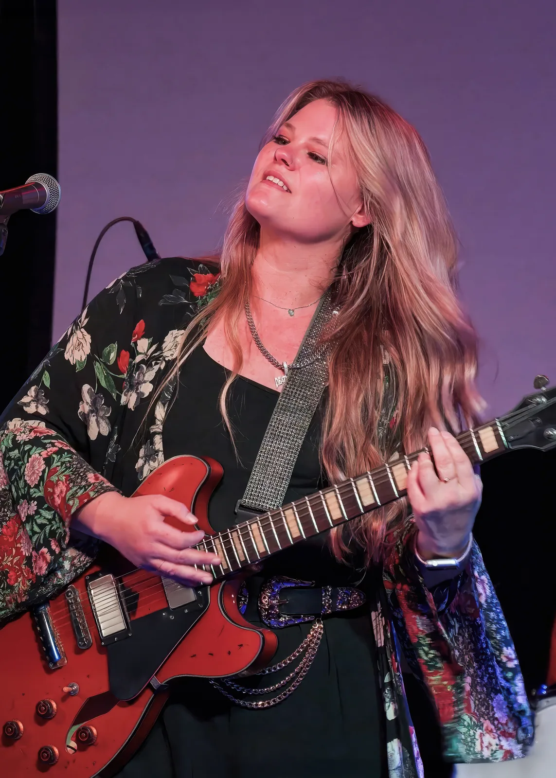 A singer with a red guitar on the stage at 3rd and Lindsley, Nashville