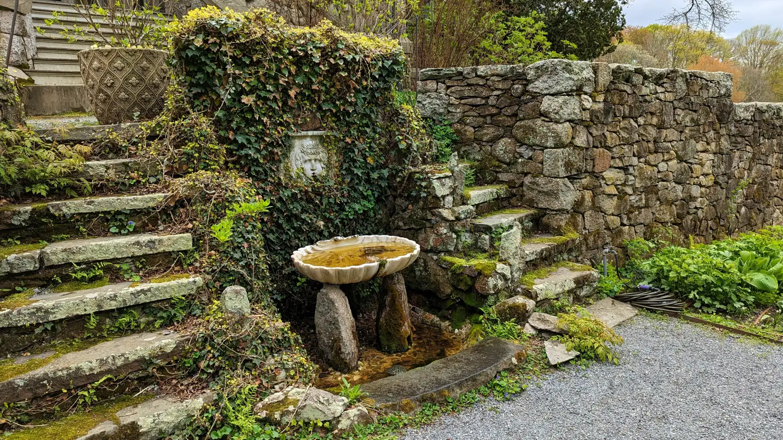 Stone steps and a fountain in the gardens at Blithewold Mansion, Bristol