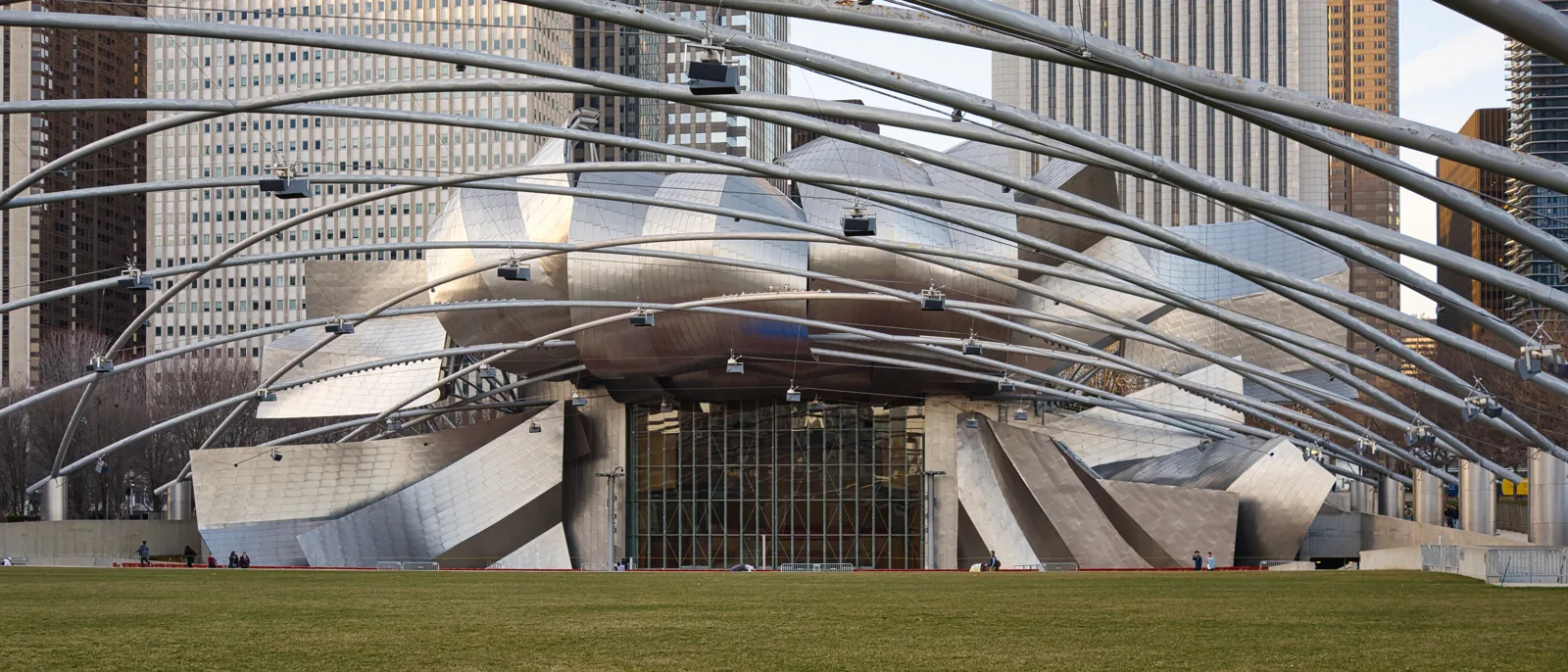 The Jay Pritzker Pavilion stage and its steel trellis over the lawn at Millennium Park, Chicago