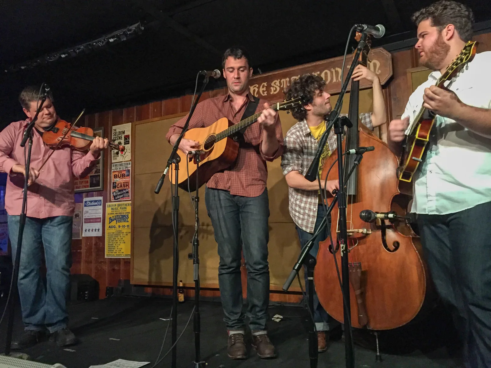 A bluegrass band with fiddle, guitar and upright bass on the Station Inn stage
