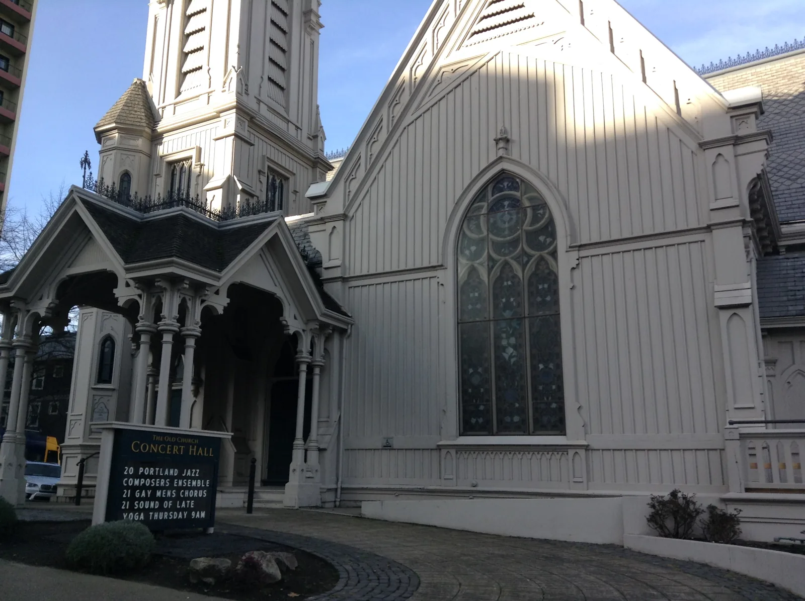 The white wooden facade and spire of The Old Church concert hall, Portland